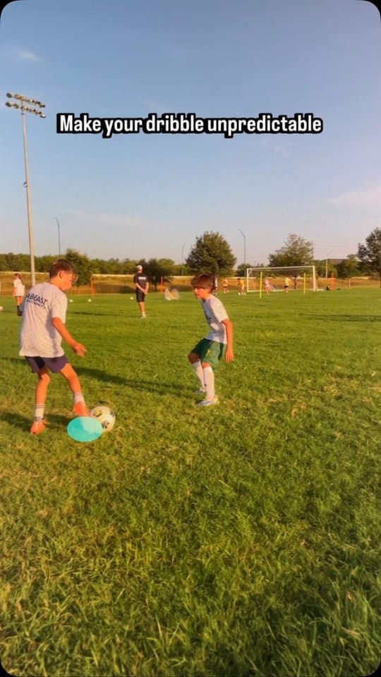 Young players working on a dribbling move at training